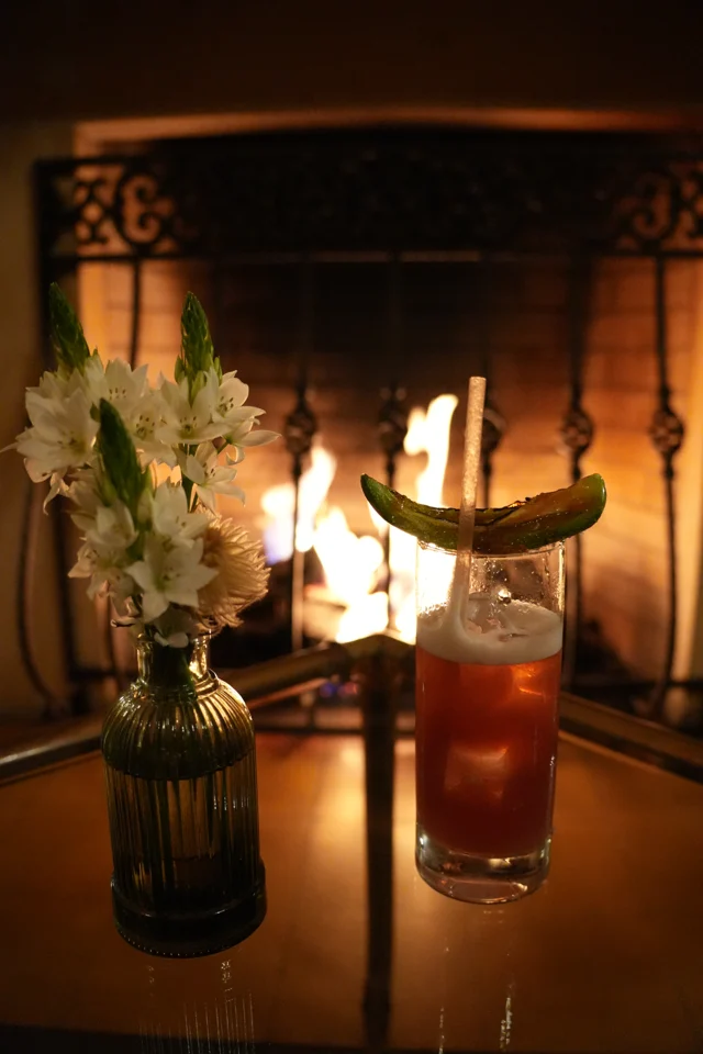 Drinks and flowers by the fireplace