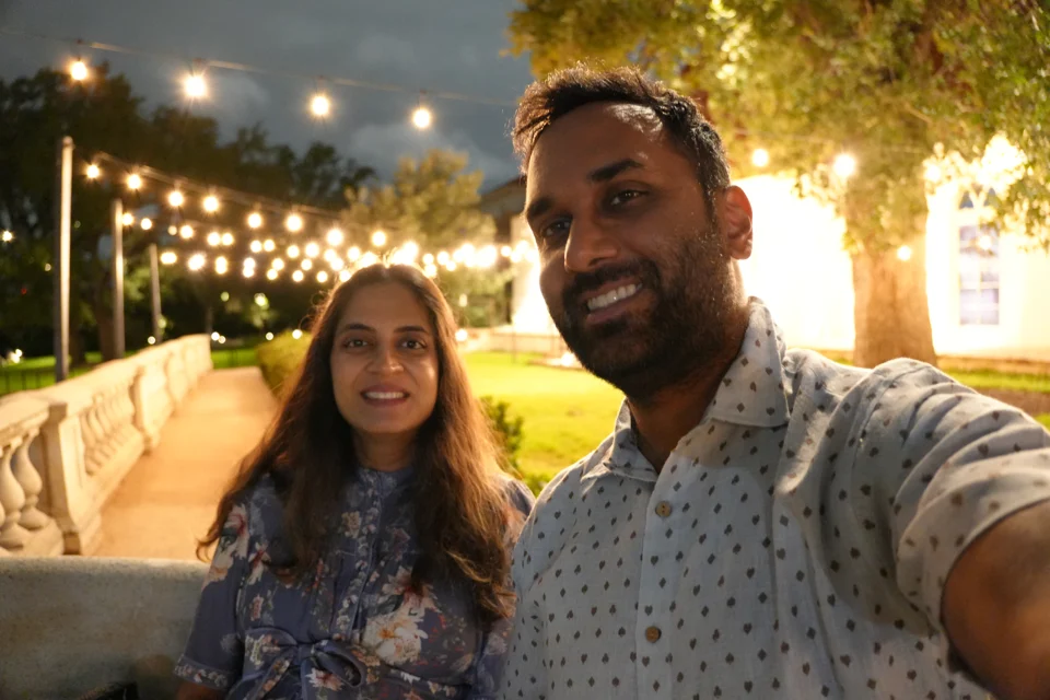 An evening selfie beneath the estate lights