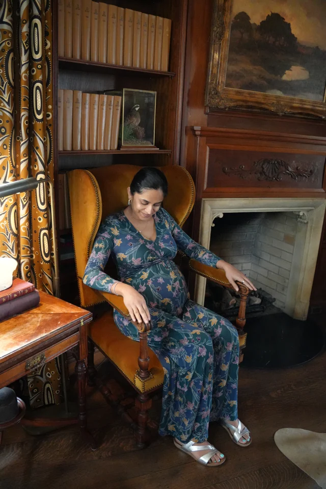 Mital relaxing in the library armchair