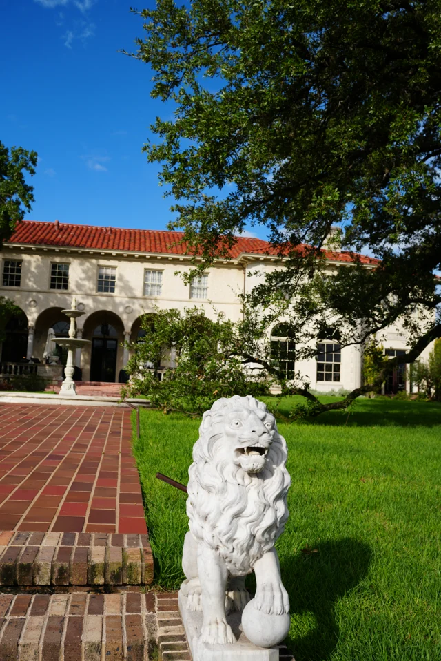 A lion statue and the mansion facade