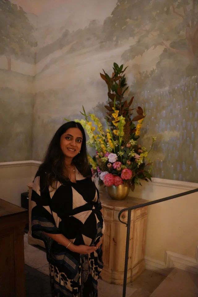 Mital beside the foyer flowers
