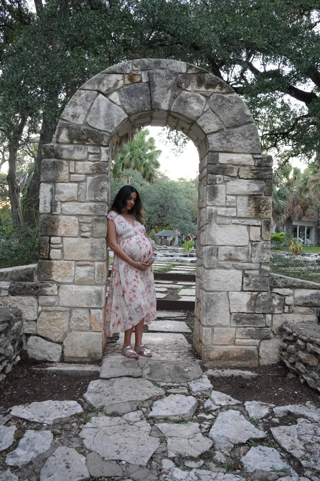 Mital beneath a stone garden arch at Mayfield Park