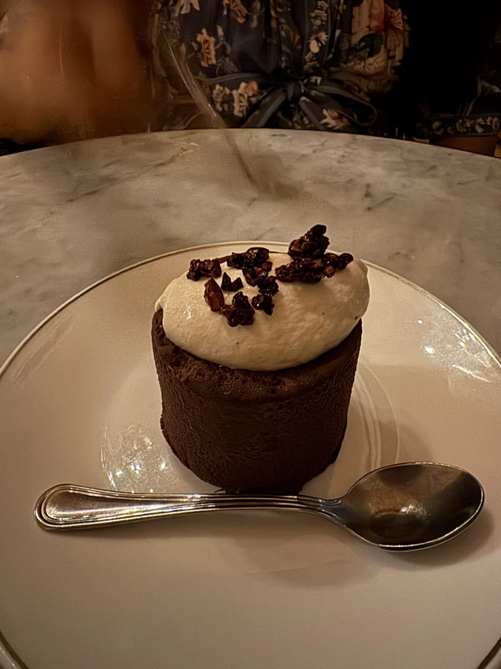 Dessert at the Mansion, topped with cream and served on a white plate